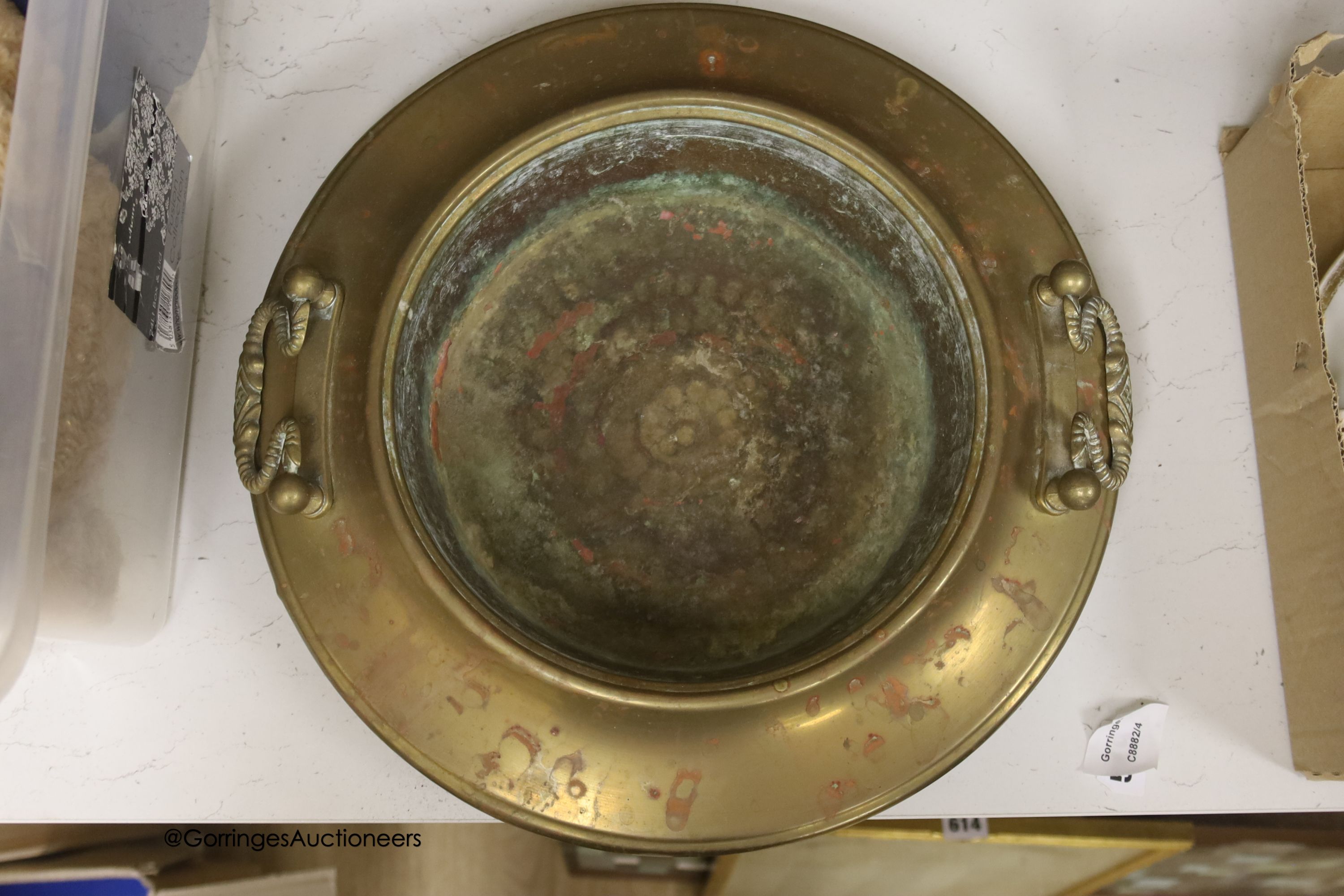 A circular brass two handled bowl, diameter 38cm